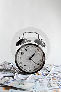 Alarm clock on money banknotes Dollars, concept of business planning and finance. Usurer, credit concept. Time for quick money.Tim