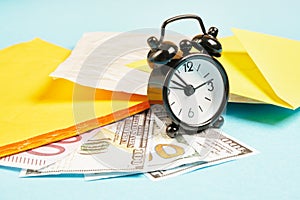 Alarm clock, money and parcels on blue background, mail concept, tracking parcels