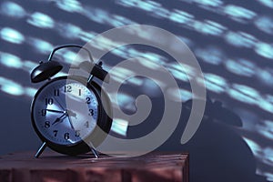 Alarm clock on night table in bedroom