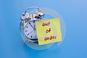 Alarm clock with note 'out of order'