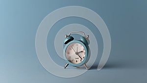 Alarm clock over a blue colour background