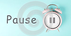 Alarm clock with pause sign, pastel color, time for a break, having lunch or a cup of coffee