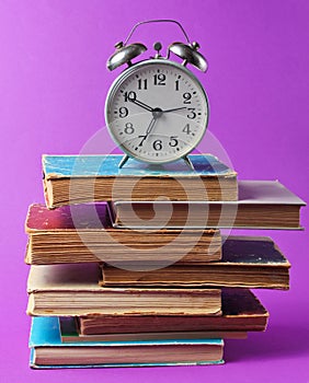 Alarm clock on purple background