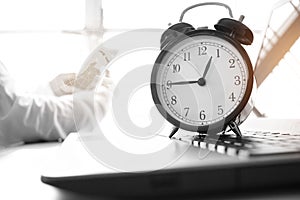 Alarm clock with Radar background on computer, businessman using