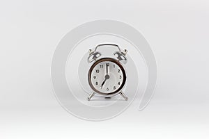 Alarm clock in retro vintage style at 7 o`clock hands isolated on white background. Minimal modern style