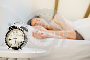 Alarm clock ringing.Woman waking up in early morning for work.Obstructive sleep apnea effects.Mental stress sleep depression.