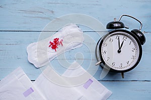 Alarm clock with sanitary pad and red yarn