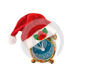 Alarm clock with Santa hat isolated over white.