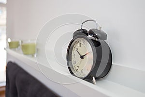 Alarm clock on a shelve photo