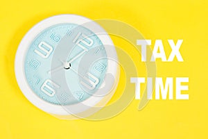 Alarm Clock showing 7 o`clock with near tax time concept