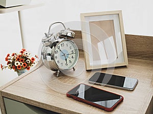 Alarm clock and smartphone in the bed room