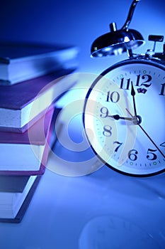 Alarm clock and stack of books