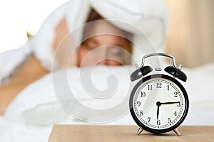 Alarm clock standing on bedside table going to ring