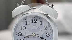 Alarm clock standing on table and ringing, time for awakening, deadline urgency