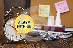 On the alarm clock a sticker with the inscription - ALARM FATIGUE