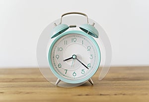 Alarm clock on the table background. Morning time and beginning of the day, timing, deadline concept