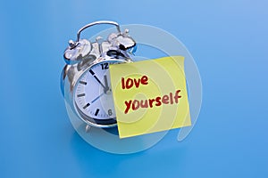 Alarm clock with text: 'love yourself'