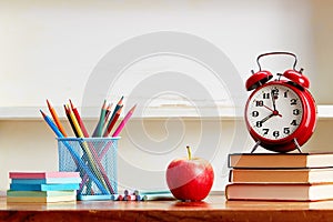 Alarm Clock On Top Of Books On Table