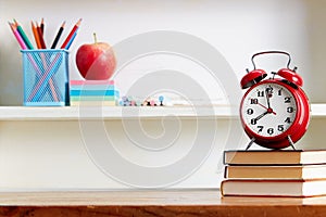 Alarm Clock On Top Of Books On Table