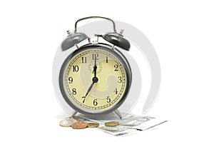 Alarm clock on top of coins and paper money
