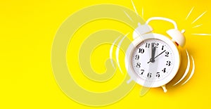 Alarm clock on yellow background top view Flat lay copy space. Minimalistic background, concept of time, deadline, time to work,