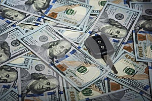 Alarm key on the background of dollar bills