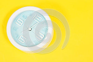 Alarm showing 7 o` Clock on yellow background