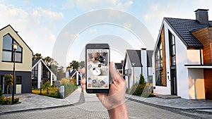 Alarm system. African-American man monitoring CCTV cameras on smartphone outdoors, closeup