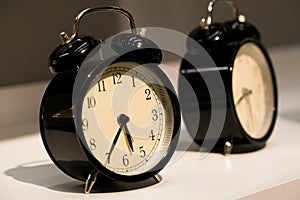 The alarm vintage clocks face on the table