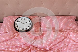 alarmclock on the bed at the morning. Waking up on an alarm clock. Good morning. Healthy sleep. The biological clock