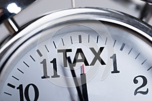 Alarmclock Showing Arrival Of Tax Time photo