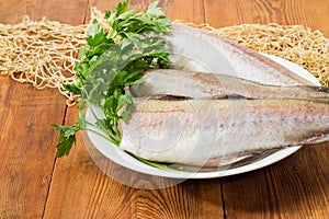 Alaska pollock carcasses on old rustic table with fishing net