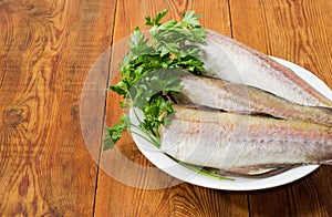 Alaska pollock on dish located on right on rustic table