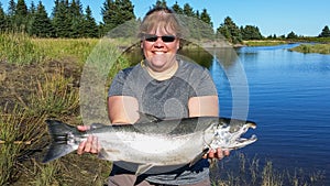 Alaska Woman Holding Silver Salmon Lake Clark National Park photo