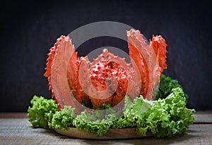 Alaskan King Crab Cooked steam or Boiled seafood and lettuce salad vegetable with dark background - red crab hokkaido