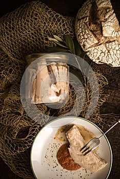 Albacore canned in glass jar with olive oil, vertical image photo