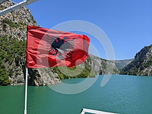 Albania national flag on a ferry across Lake Koman