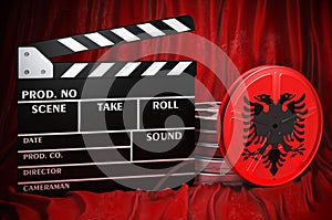 Albanian cinematography, film industry, cinema in Albania. Clapperboard with and film reels on the red fabric, 3D rendering