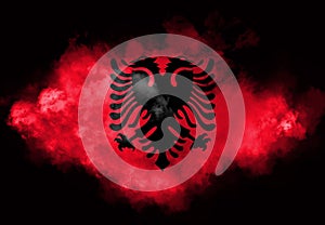 Albanian flag performed from color smoke on the black background. Abstract symbol photo
