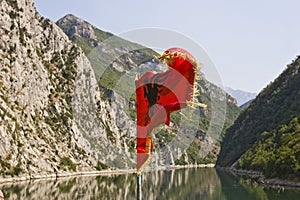 Albanian national flag on Komani lake