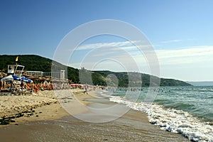 Albena Resort, Dobrich region, Balchik, Bulgaria - 08.04.2014. Vacationers on a sandy beach enter the Black Sea