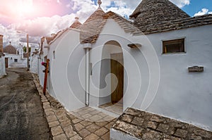 Alberobello, Puglia, Italy. August 2021. Amazing view on one of the alleys of the village. The trulli, typical white houses with a