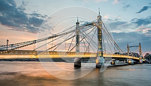 Albert Bridge and beautiful sunset over the Thames, London England UK