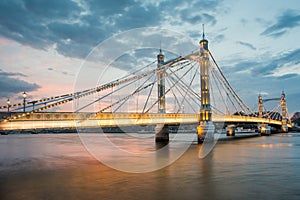 Albert Bridge and beautiful sunset over the Thames, London England UK