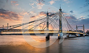 Albert Bridge and beautiful sunset over the Thames, London England UK