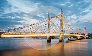 Albert Bridge and beautiful sunset over the Thames, London England UK