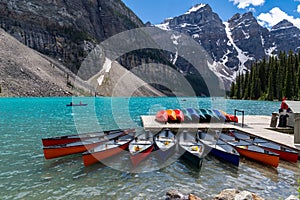 Canoes at the boathouse on Morinae Lake in the summer in the Canadian Rockies