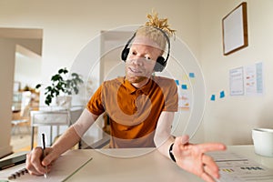 Albino african american man working from home making video call photo