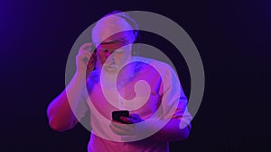 An albino grandpa dancing while wearing new earphones and changing songs with his phone, isolated on a cool, unique background