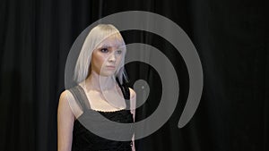 Albino model walks on runway podium. Fashion show vogue girl catwalk defile.